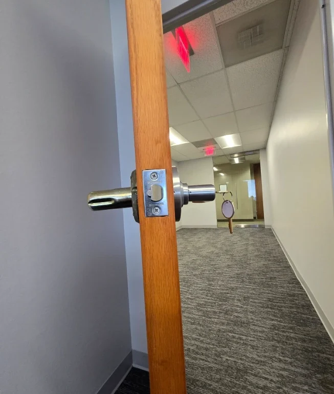Licensed commercial locksmith installing door hardware at Aiken SC business property